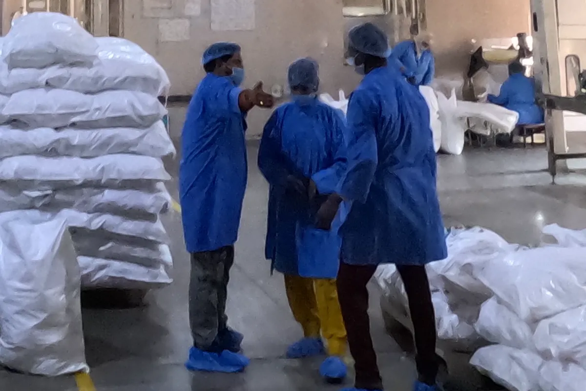 Packing team in gowns, hairnets and masks at the Jaspur plant