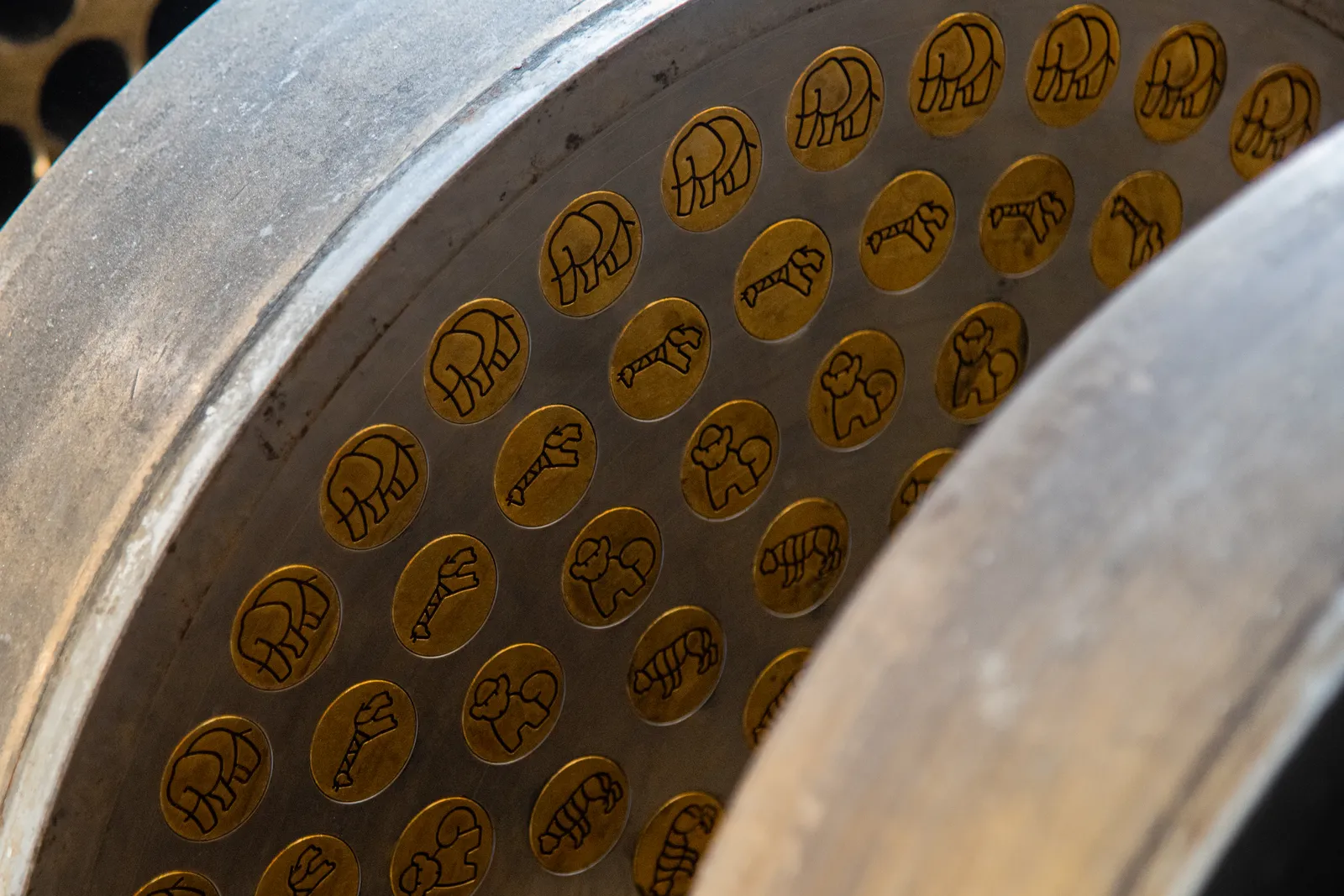 Pasta die inserts in rows on a die ring, each cut with an animal outline