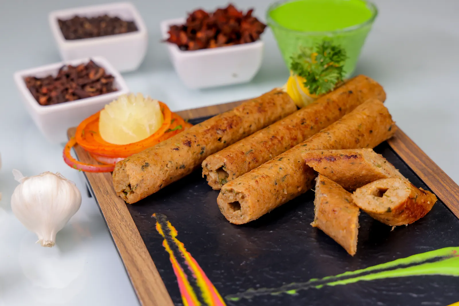 Zippy soya protein seekh kebabs on a serving board, one cut into pieces