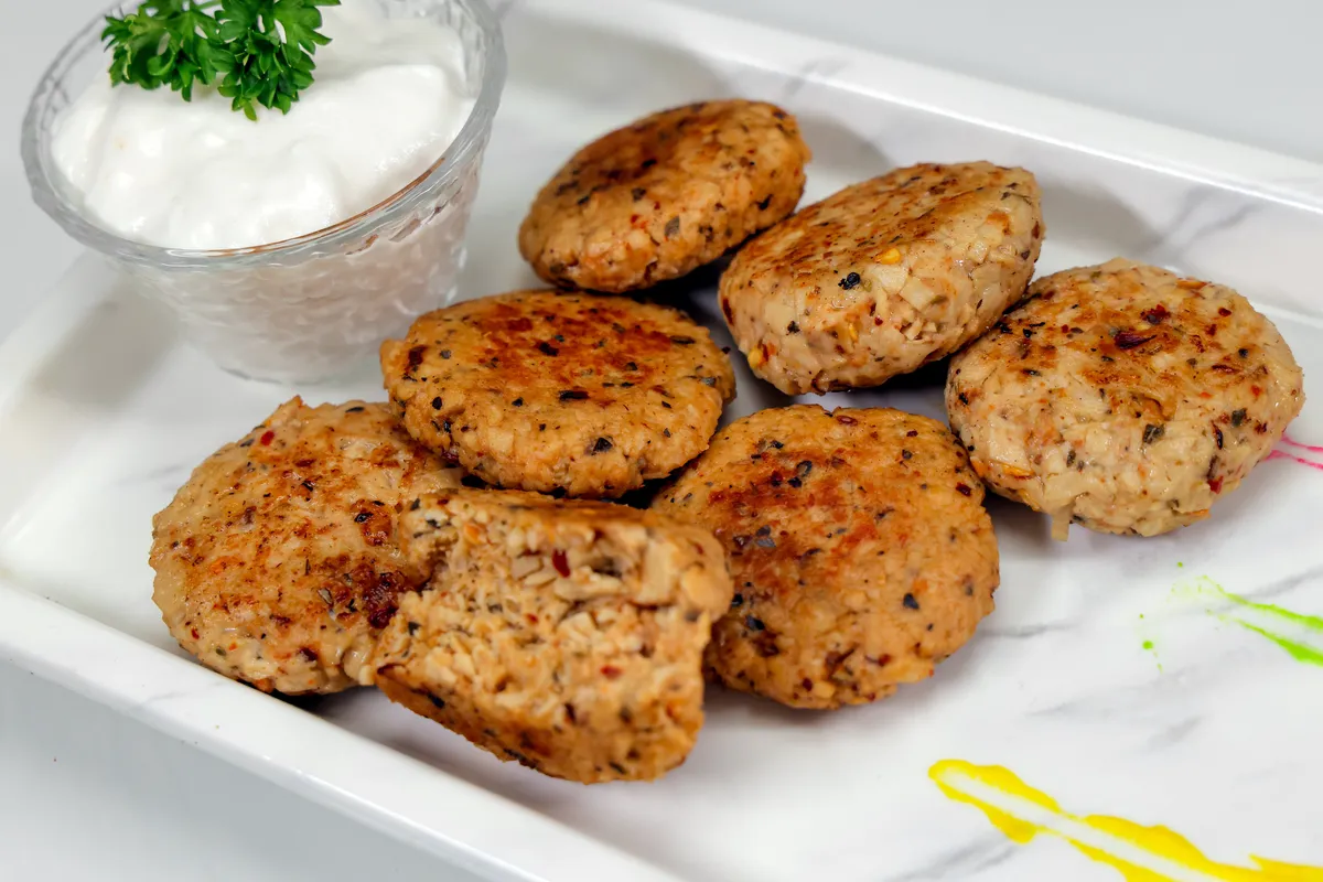 Zippy herb and chilli soya protein patties on a white platter